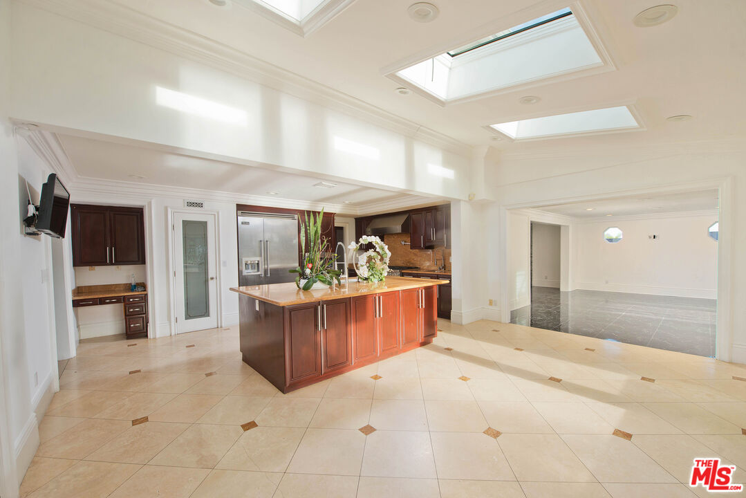 11753 Castillo Lane Porter Ranch, CA 91326 - Photo 14 of 44 a view of living room kitchen with stainless steel appliances granite countertop cabinets and window