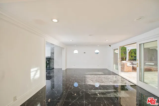 a view of a big room with windows and entryway