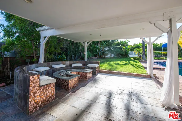 a backyard of a house with yard and outdoor seating