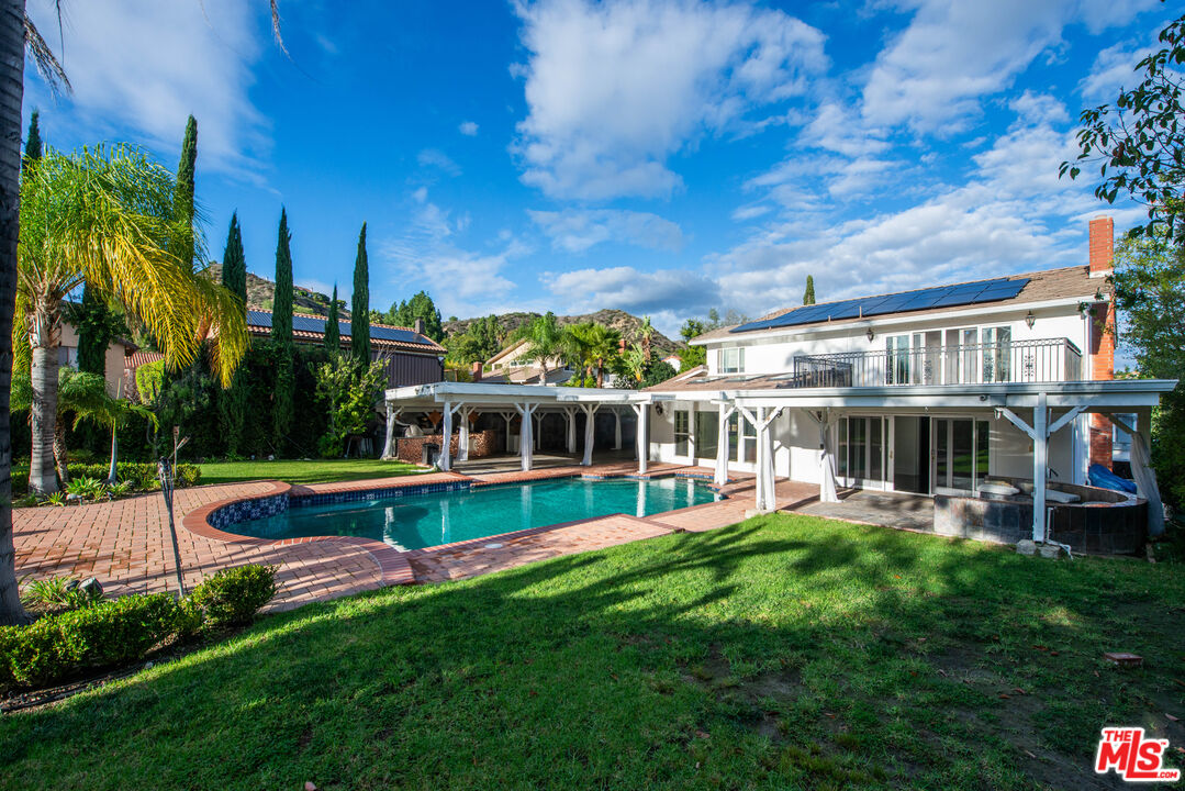 11753 Castillo Lane Porter Ranch, CA 91326 - Photo 25 of 44 a view of a house with a backyard