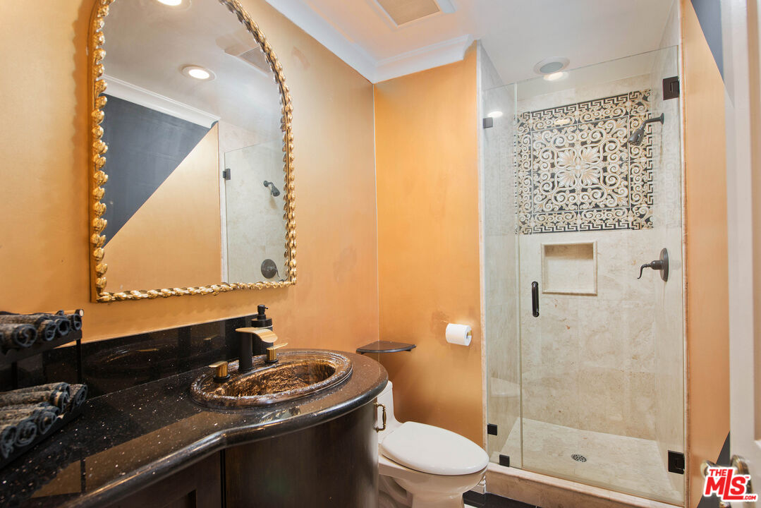 11753 Castillo Lane Porter Ranch, CA 91326 - Photo 28 of 44 a bathroom with a granite countertop sink toilet and shower