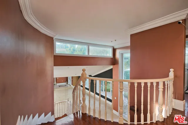 a bedroom with a large bed and glass windows