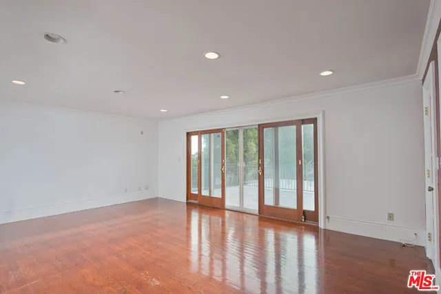 a view of a hallway with wooden cabinets