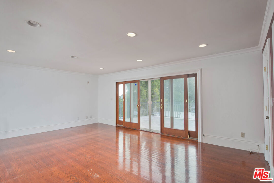 11753 Castillo Lane Porter Ranch, CA 91326 - Photo 32 of 44 a view of an empty room with wooden floor and a window