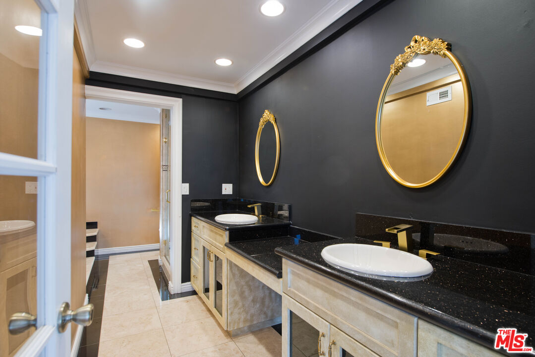 11753 Castillo Lane Porter Ranch, CA 91326 - Photo 34 of 44 a bathroom with a double vanity sink and a mirror