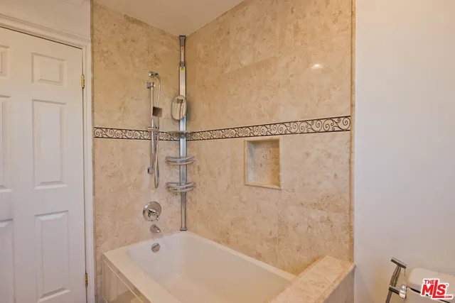 an aerial view of a house with outdoor space and seating area