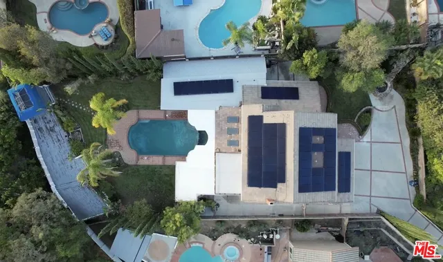 an aerial view of a house with pool patio and outdoor seating