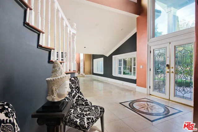 a balcony with furniture and a potted plant