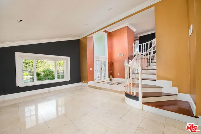 a view of an empty room with stairs