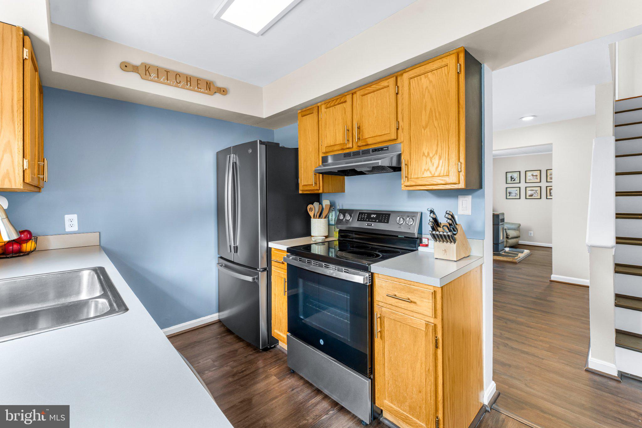 7800 Appletree Road Pasadena, MD 21122 - Photo 22 of 33 Modern kitchen with warm wood accents.