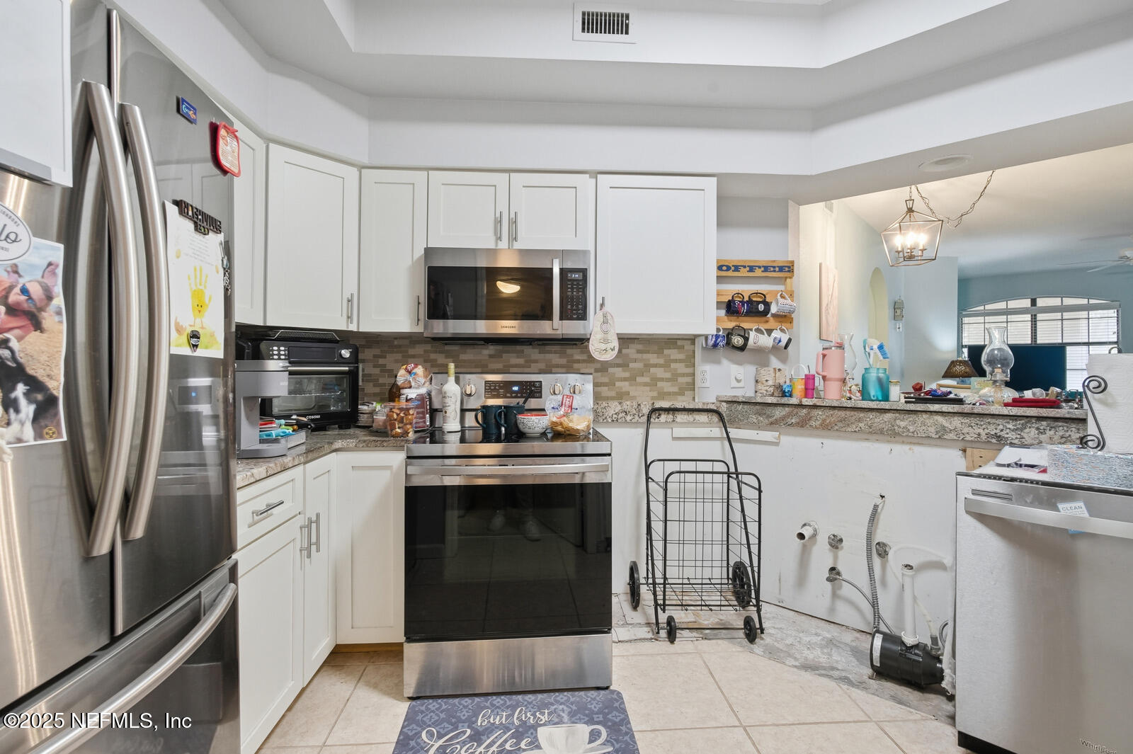 1810 Vista Cove Road St. Augustine, FL 32084 - Photo 26 of 43 a kitchen with appliances a sink and cabinets
