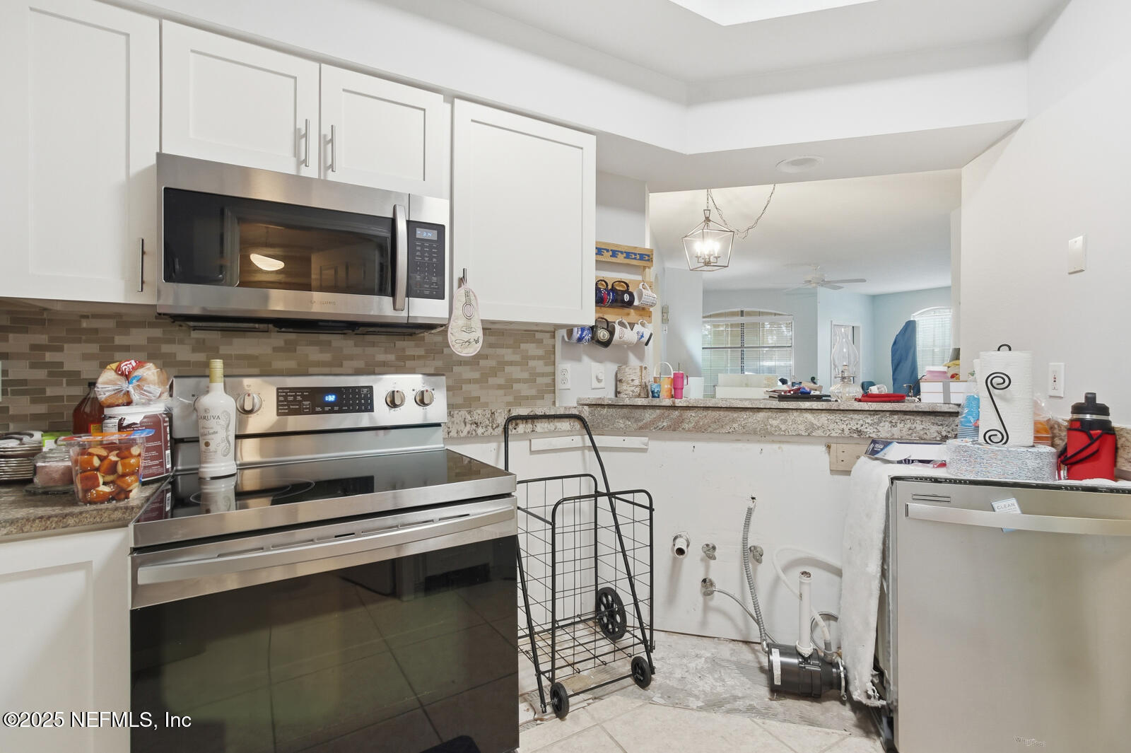 1810 Vista Cove Road St. Augustine, FL 32084 - Photo 27 of 43 a kitchen with appliances a sink and cabinets