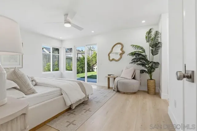 a bedroom with a large bed and a large window