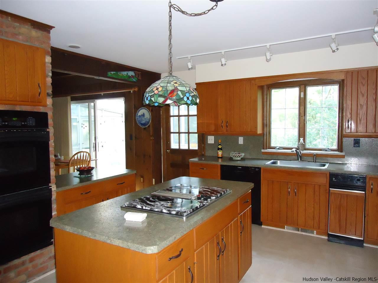 611 Hoagerburgh Road Wallkill, NY 12589 - Photo 3 of 11 a kitchen with a stove a sink a refrigerator and a dining table