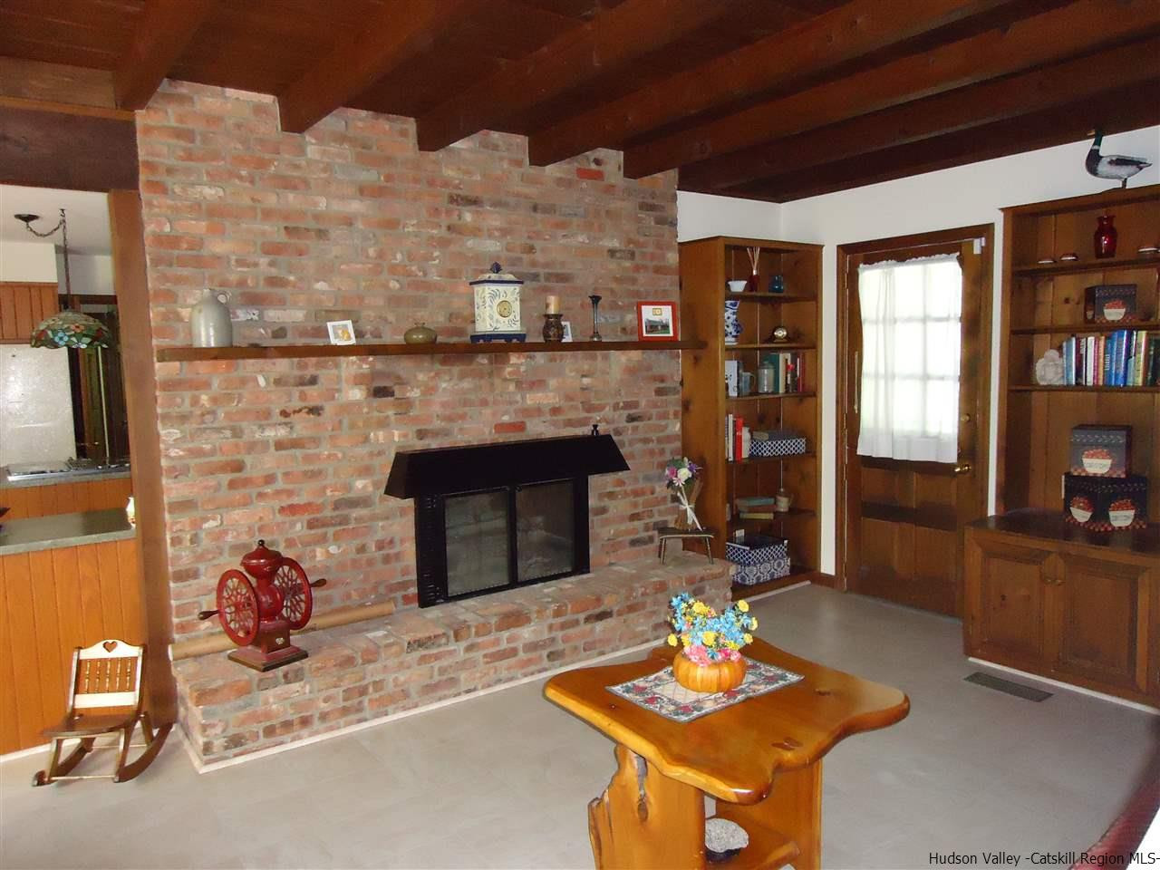 611 Hoagerburgh Road Wallkill, NY 12589 - Photo 4 of 11 a living room with furniture a flat screen tv and a fireplace