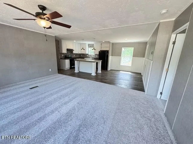 a view of a kitchen with a sink and a refrigerator