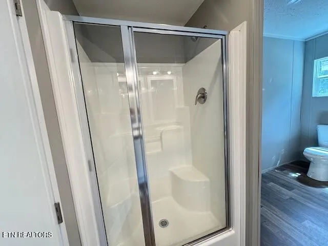 a bathroom with a glass shower door and a mirror