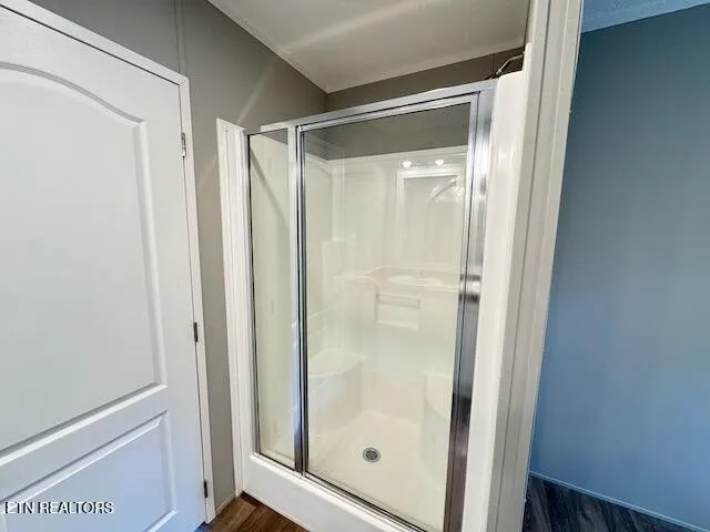 a bathroom with a glass shower door