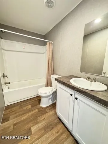 a bathroom with a sink a toilet and a shower