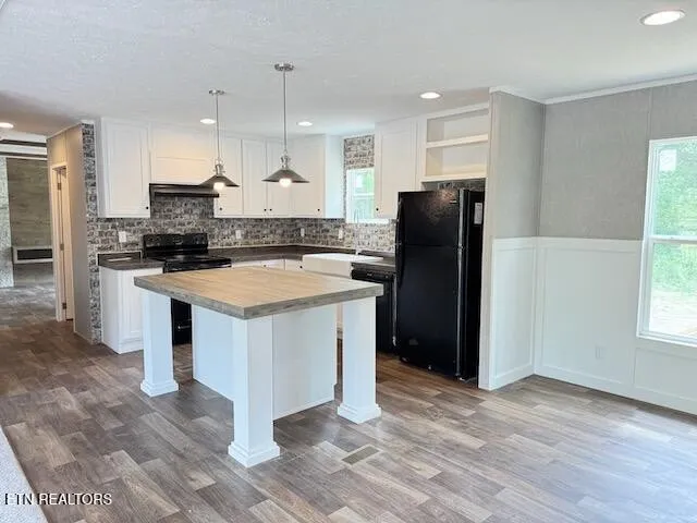 a kitchen with a refrigerator stove and sink