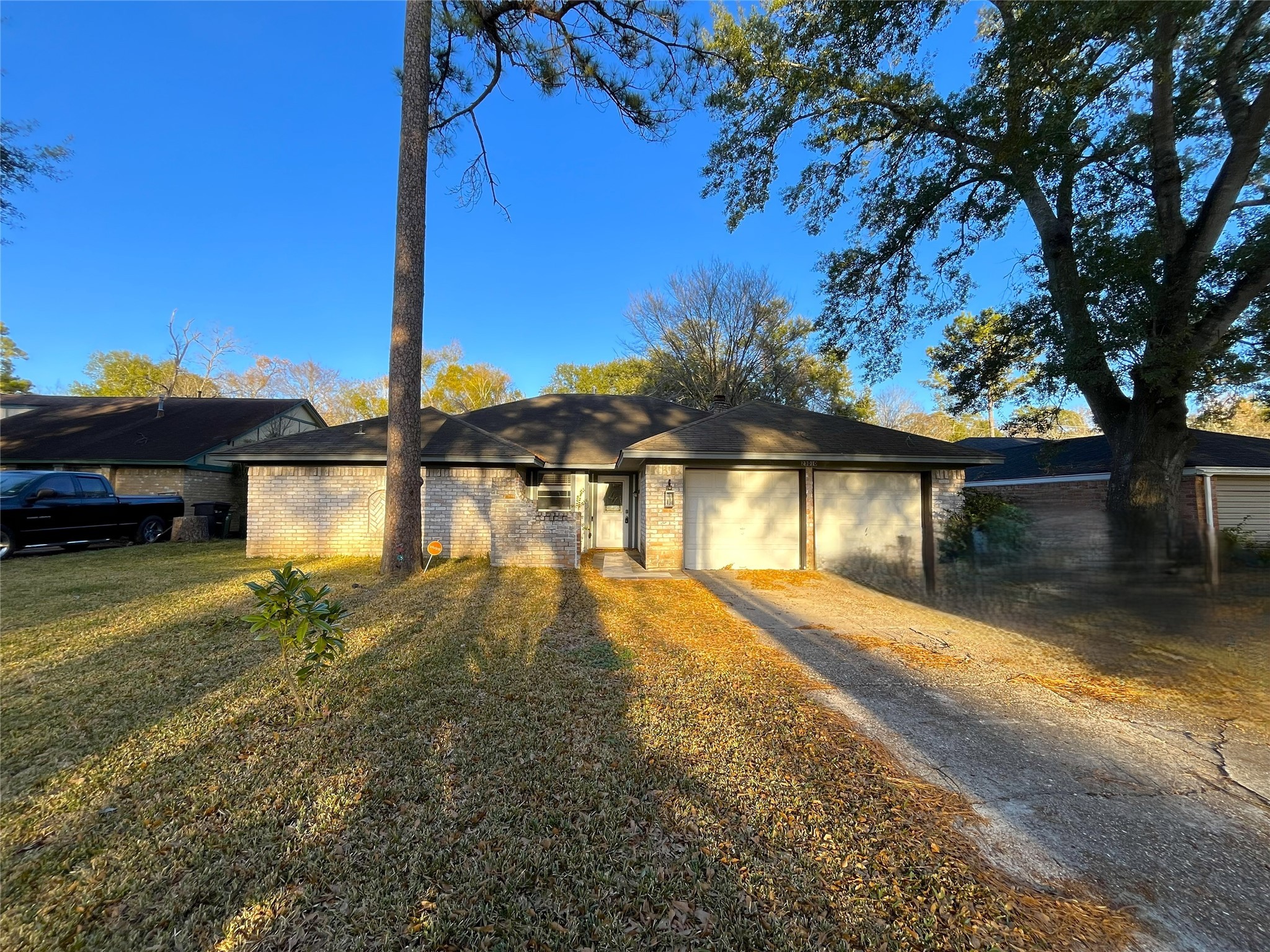 a view of a house with swimming pool next to a large tree