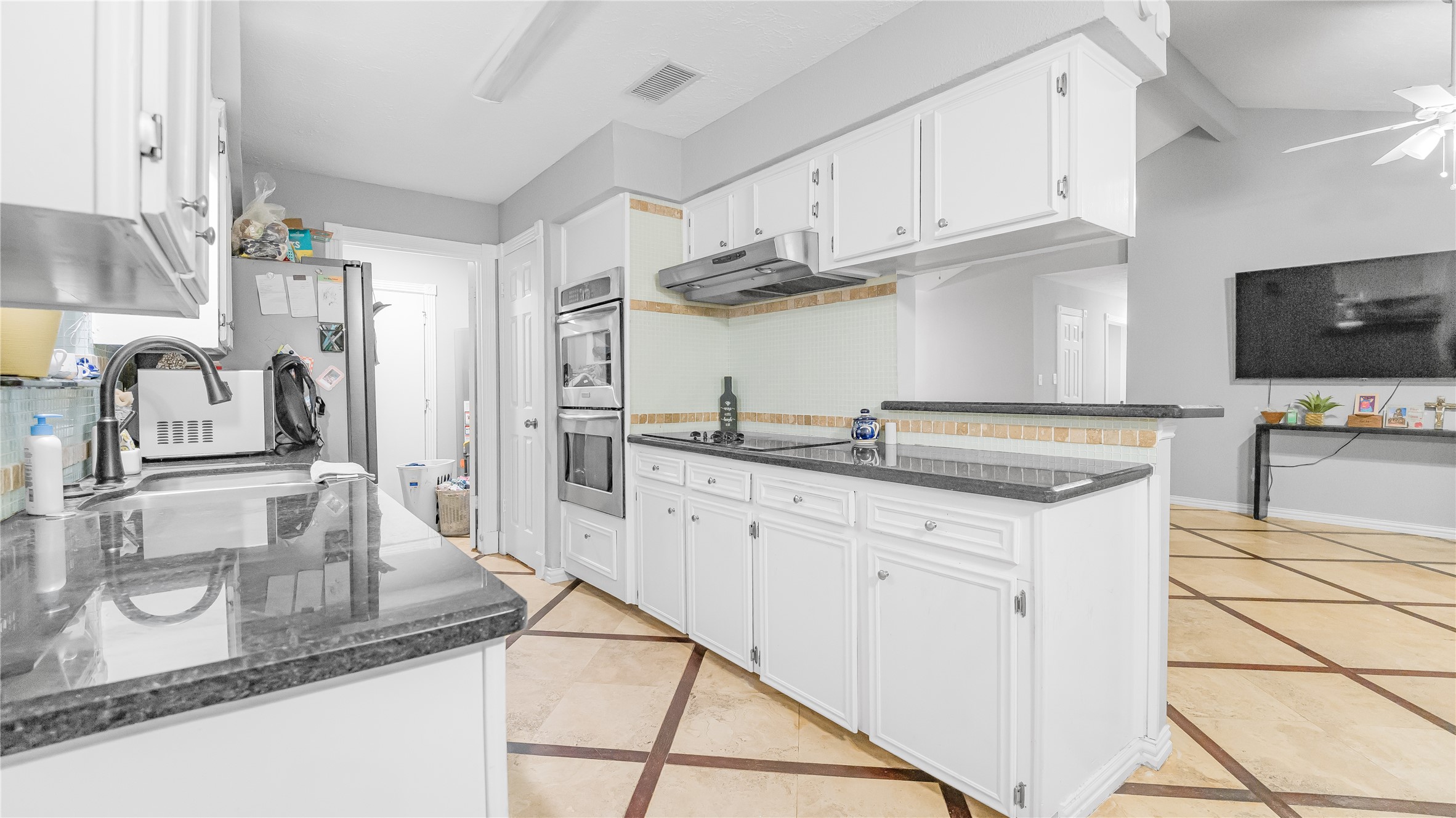 23010 Grand Rapids Lane Spring, TX 77373 - Photo 2 of 9 a kitchen with stainless steel appliances granite countertop a sink stove and cabinets