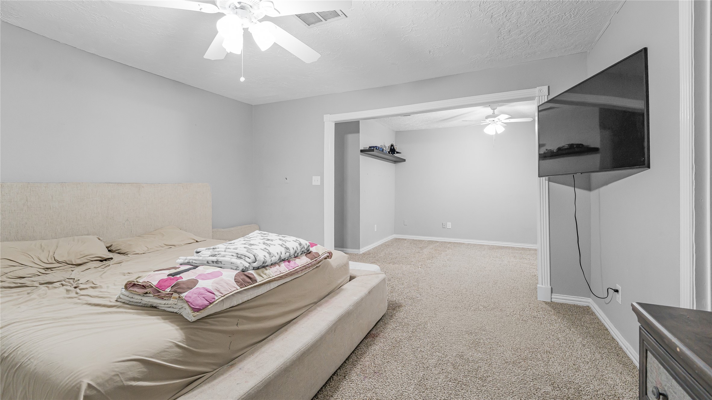 23010 Grand Rapids Lane Spring, TX 77373 - Photo 5 of 9 a bedroom with a bed and a flat screen tv