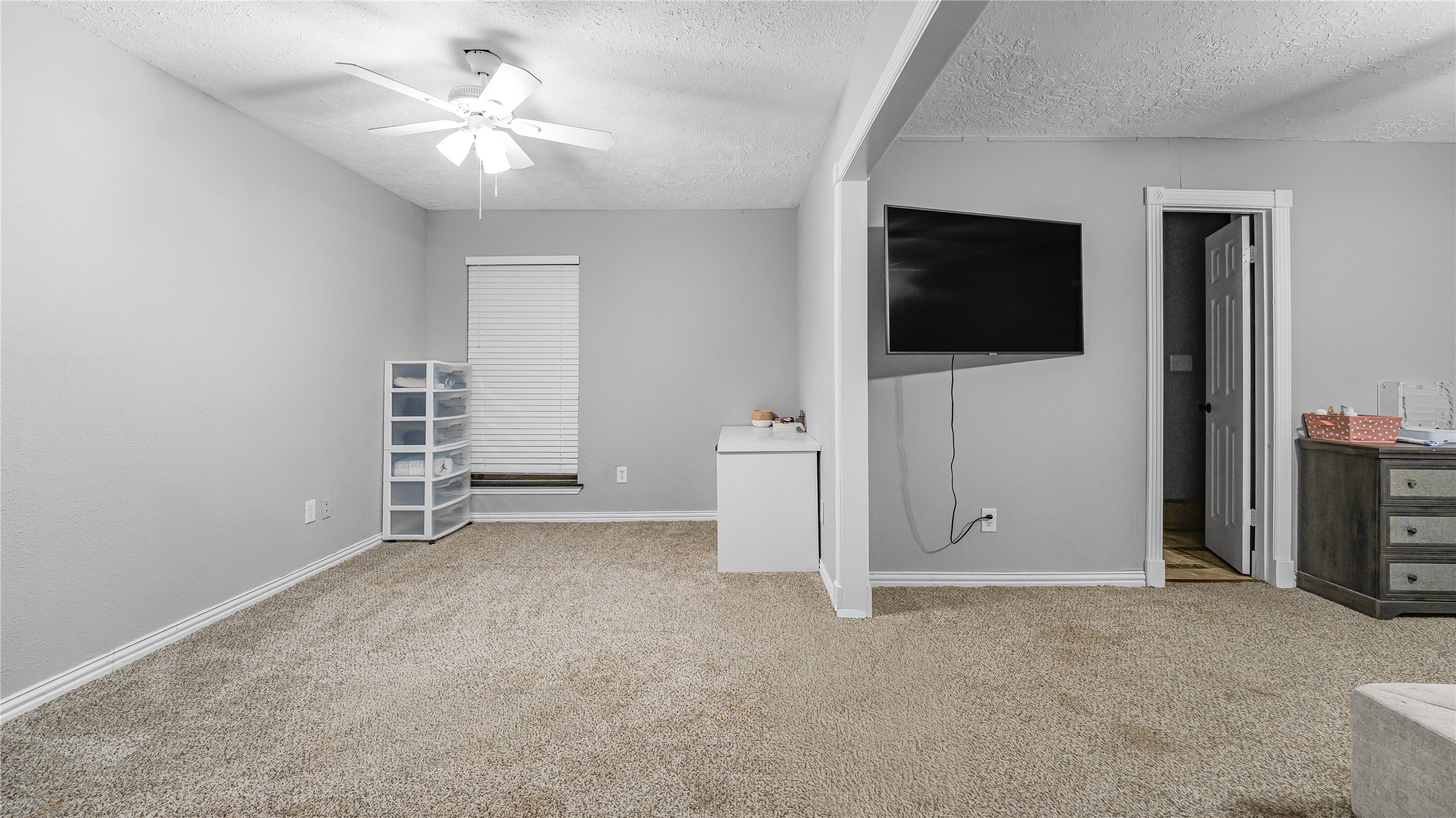 23010 Grand Rapids Lane Spring, TX 77373 - Photo 6 of 9 an empty room with windows and a flat screen tv