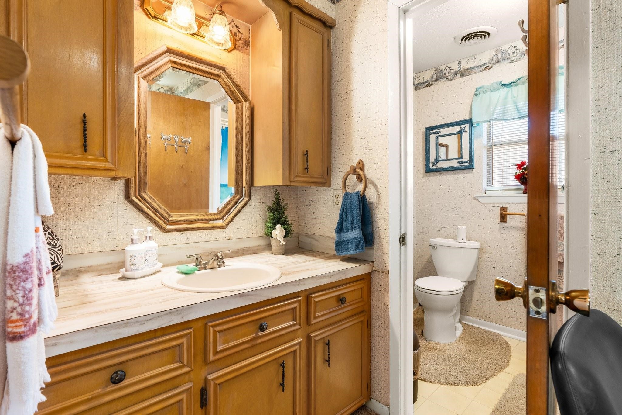 15091 Farm To Market 1485 Conroe, TX 77306 - Photo 12 of 28 a bathroom with a sink a toilet and a mirror
