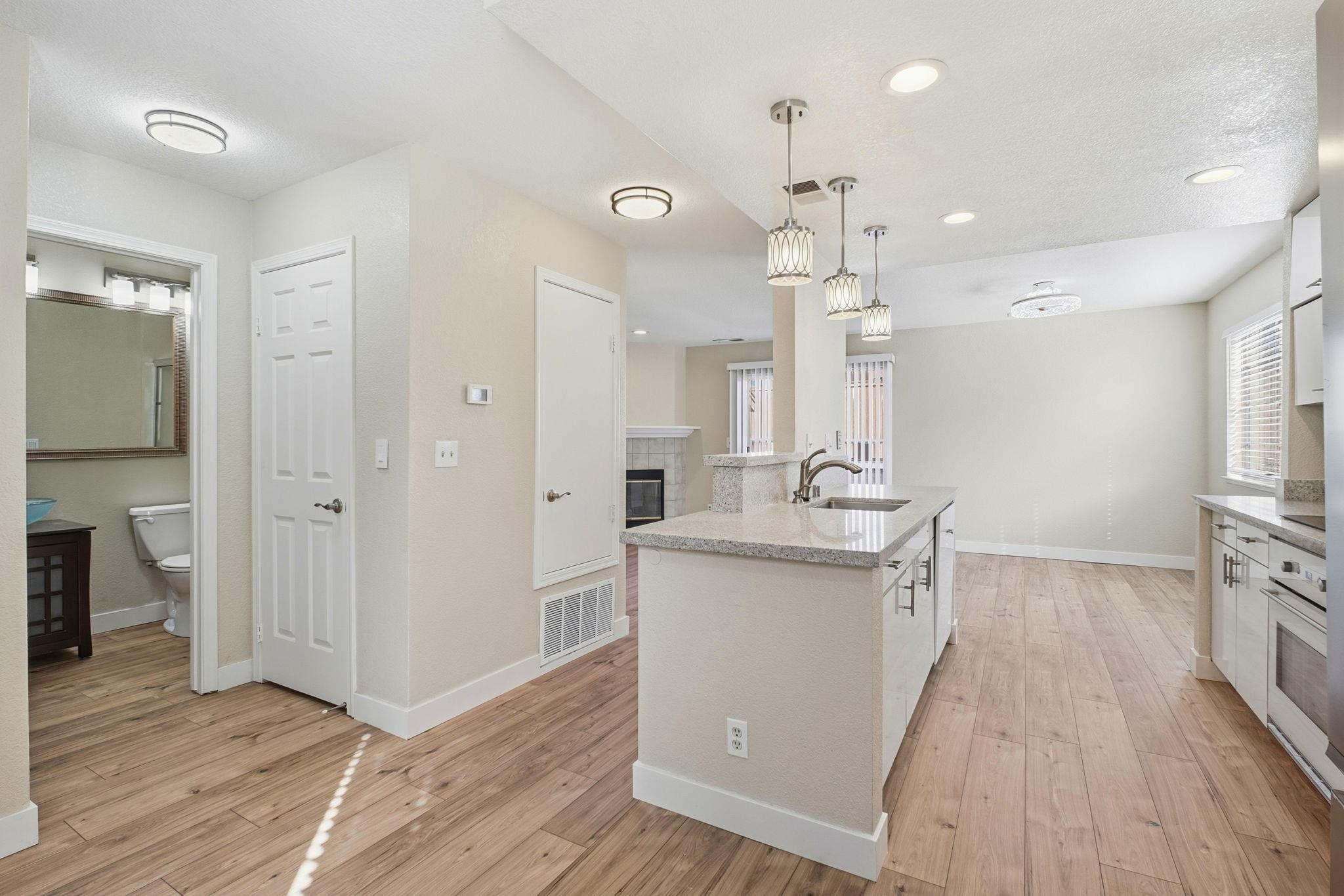 58 Trestle Drive Hayward, CA 94544 - Photo 11 of 36 a kitchen with a sink a refrigerator and wooden floor
