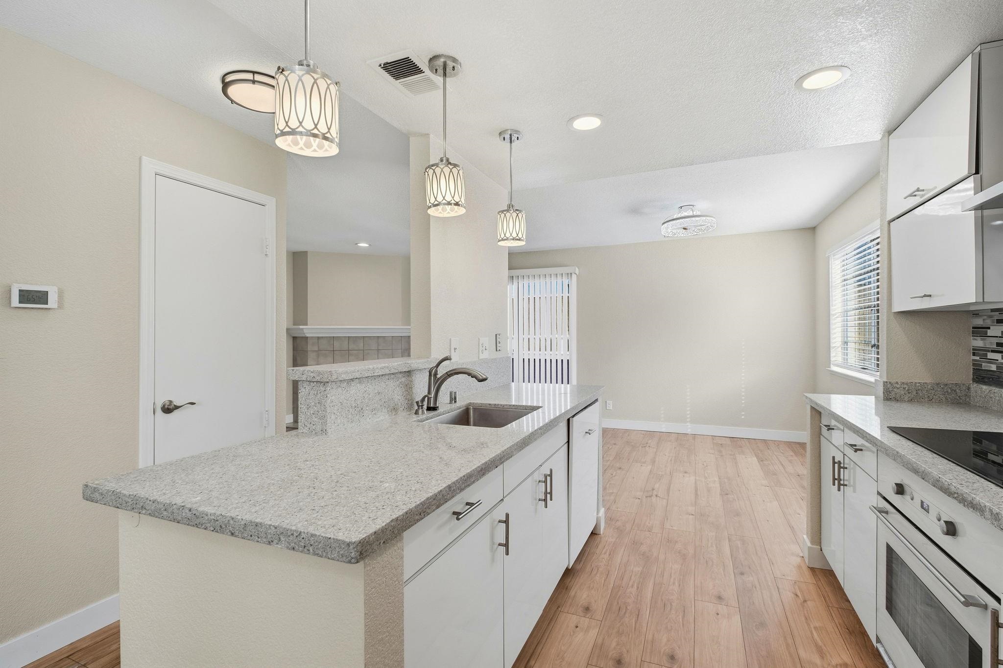 58 Trestle Drive Hayward, CA 94544 - Photo 13 of 36 a kitchen with cabinets and chandelier