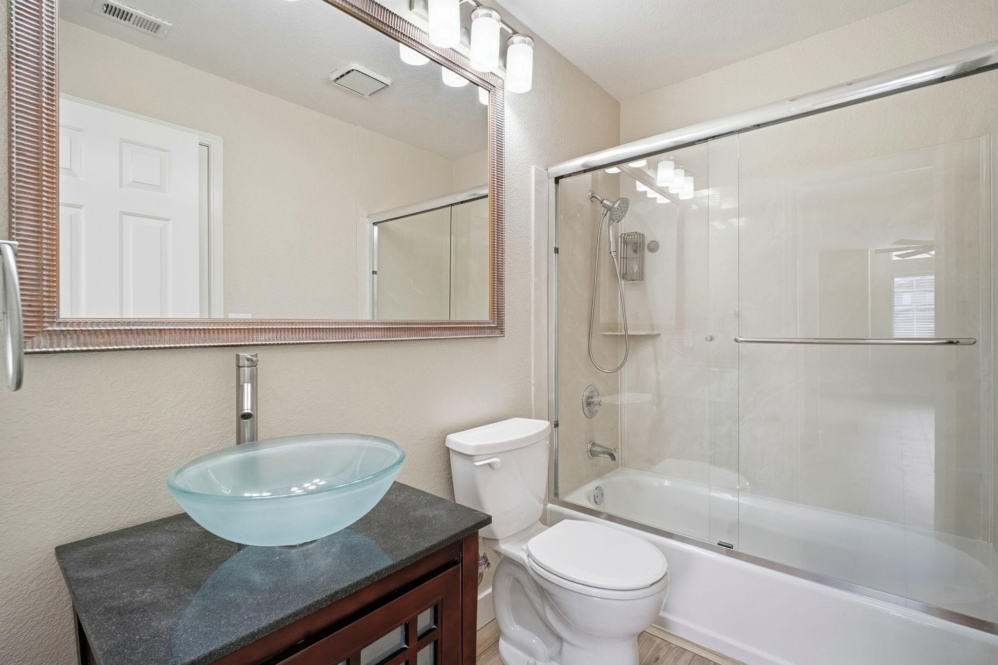 58 Trestle Drive Hayward, CA 94544 - Photo 23 of 36 a bathroom with a sink toilet a mirror and shower