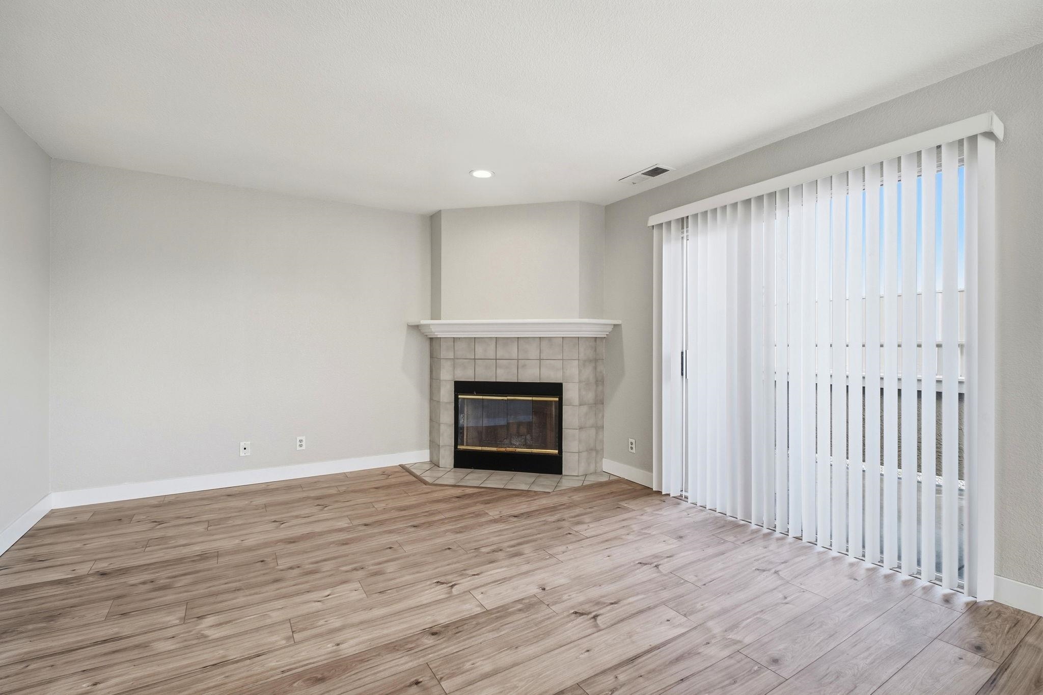 58 Trestle Drive Hayward, CA 94544 - Photo 7 of 36 a view of an empty room with wooden floor fireplace and a window