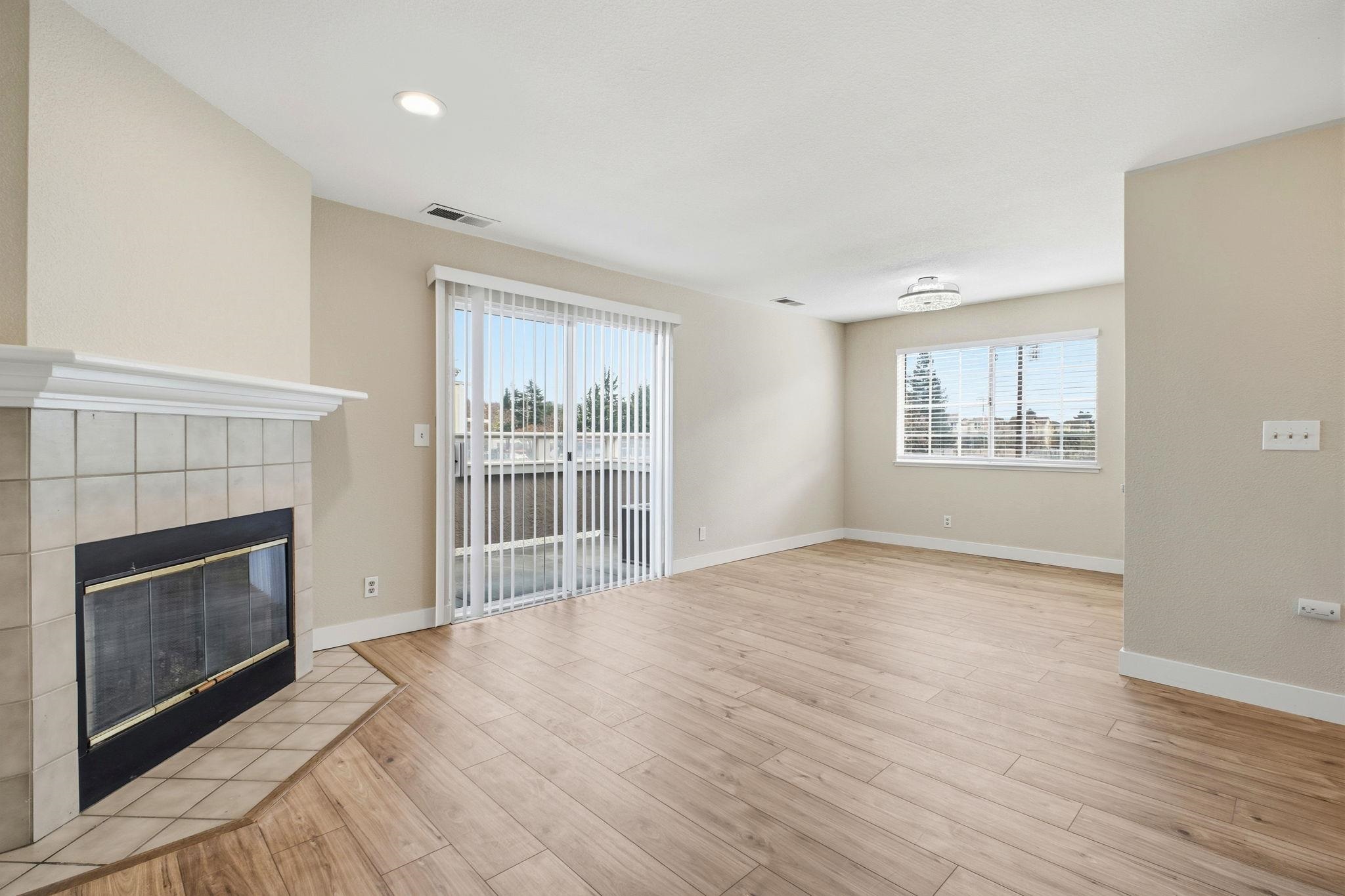 58 Trestle Drive Hayward, CA 94544 - Photo 8 of 36 a view of an empty room with a fireplace and a window