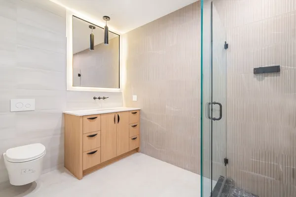 a bathroom with a sink toilet and shower