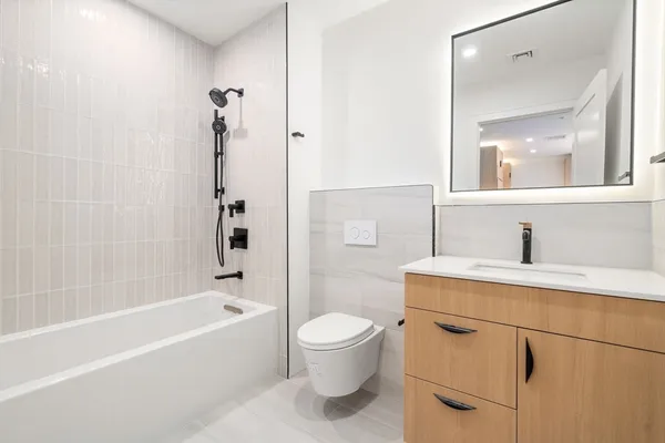 a bathroom with a sink a toilet and a mirror