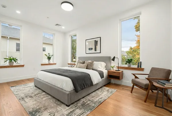 a spacious bedroom with a bed and a couch