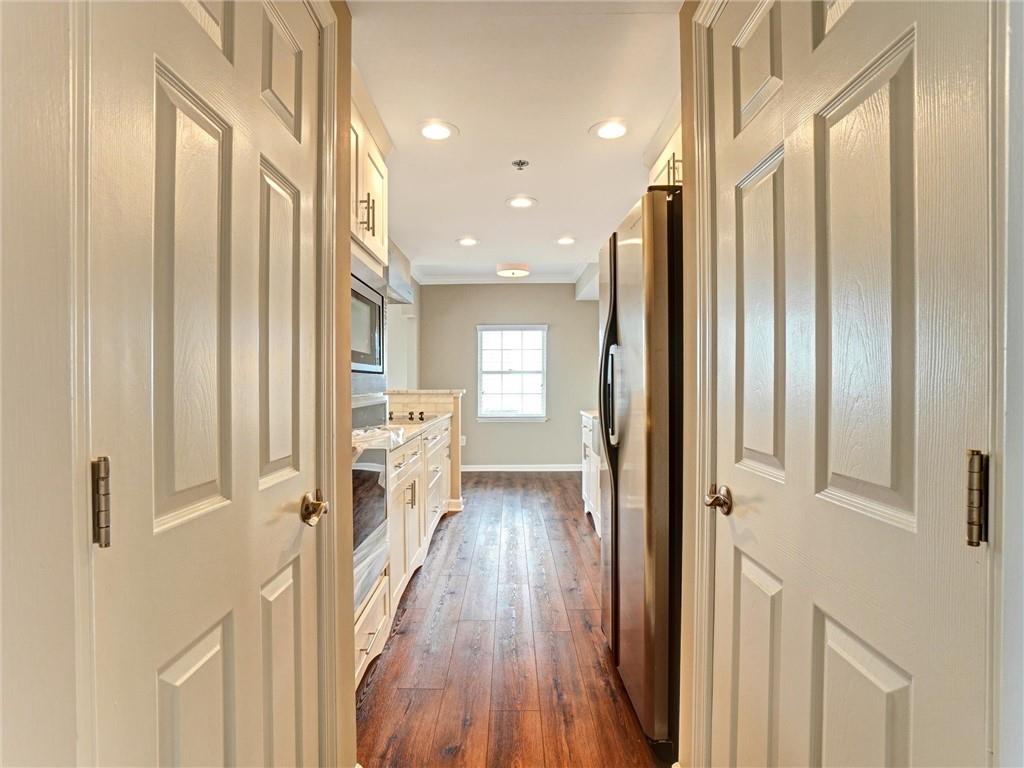 3435 Kingsboro Road Northeast, Unit 1601 Atlanta, GA 30326 - Photo 4 of 54 a view of a hallway with wooden floor and staircase