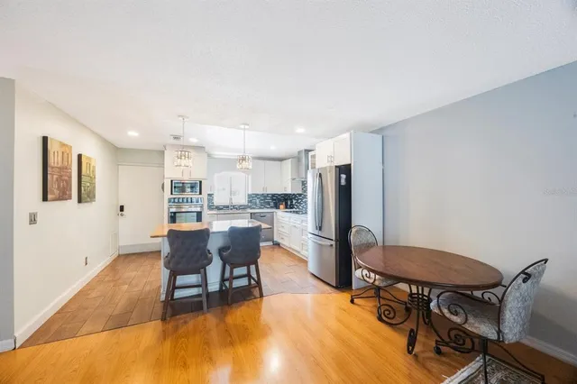 a kitchen with a stove kitchen island and living room