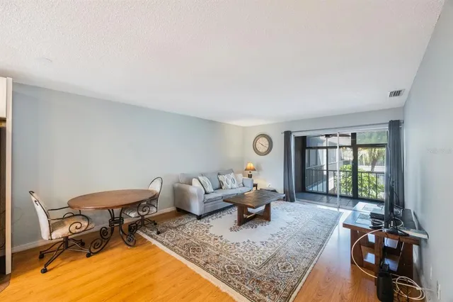 a living room with furniture a window and a flat screen tv