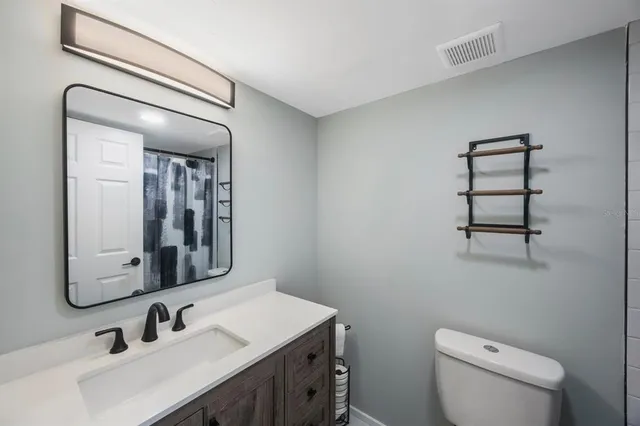 a bathroom with a shower toilet and sink