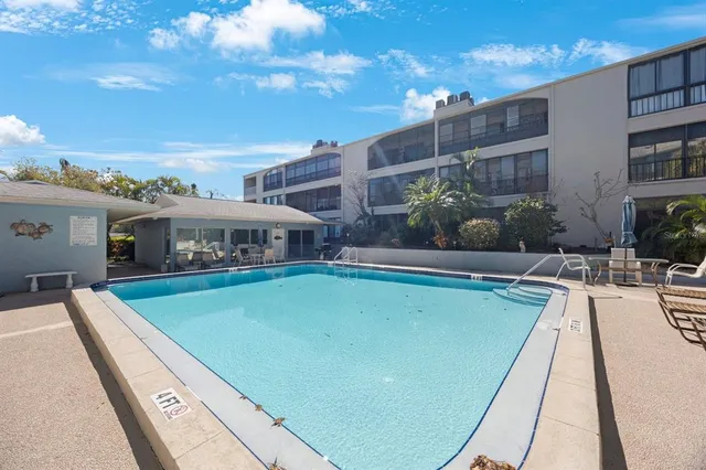 a view of a swimming pool with an outdoor seating