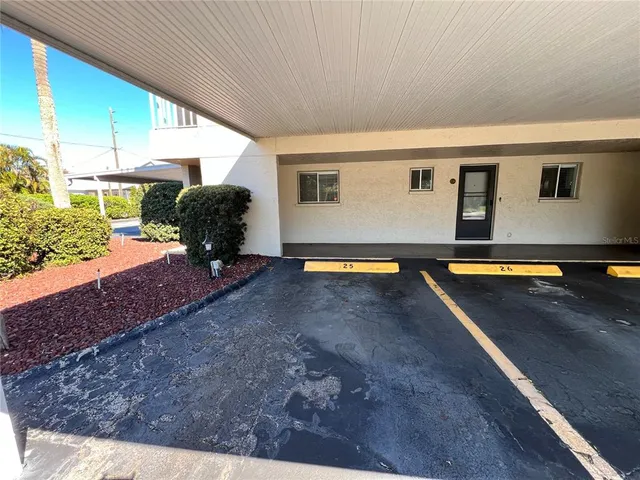 a view of a hallway with wooden floor and stairs