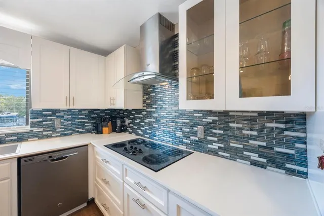 a kitchen with stainless steel appliances granite countertop a sink refrigerator and cabinets