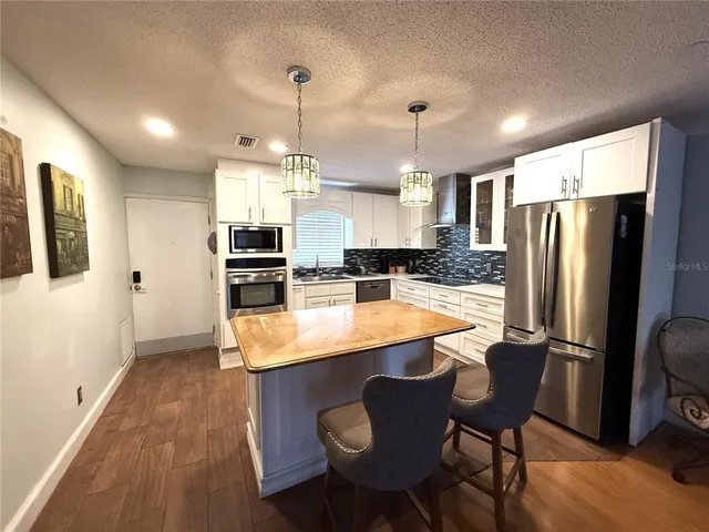 a large kitchen with a table and chairs