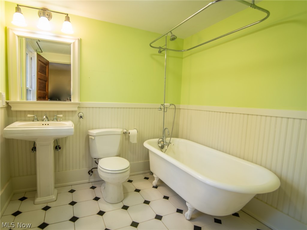 4041 Granger Road Akron, OH 44333 - Photo 16 of 34 Full bath has been remodeled with tile floors, new plumbing, wainscotting and clawfoot tub.