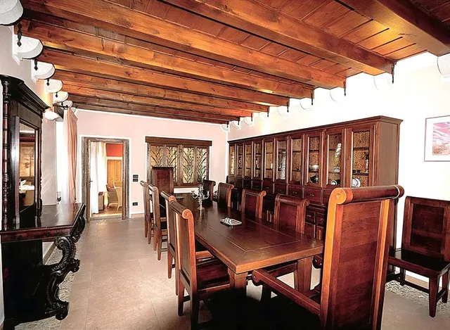 a view of a dining room with a table and chairs potted plants