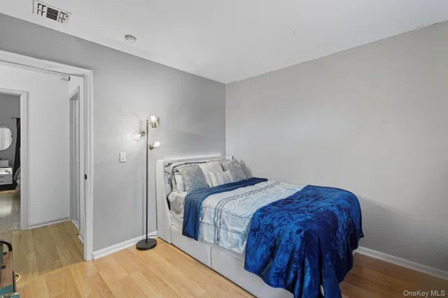 a bedroom with a bed and a lamp