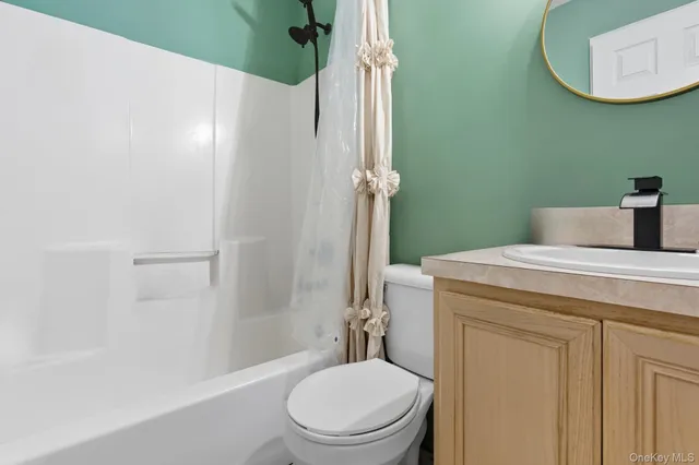a bathroom with a granite countertop toilet sink and shower