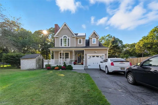 a front view of a house with a garden and parking space